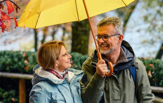 Older couple under umbrella